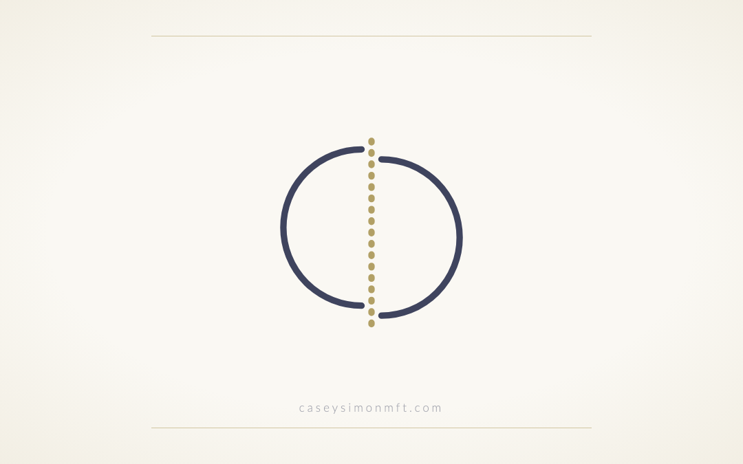 Two circle halves slightly out of alignment, joined by a dotted gold seam